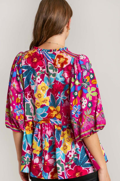 Chic floral print tie-neck peplum blouse with a flattering silhouette, perfect for a feminine and stylish look.