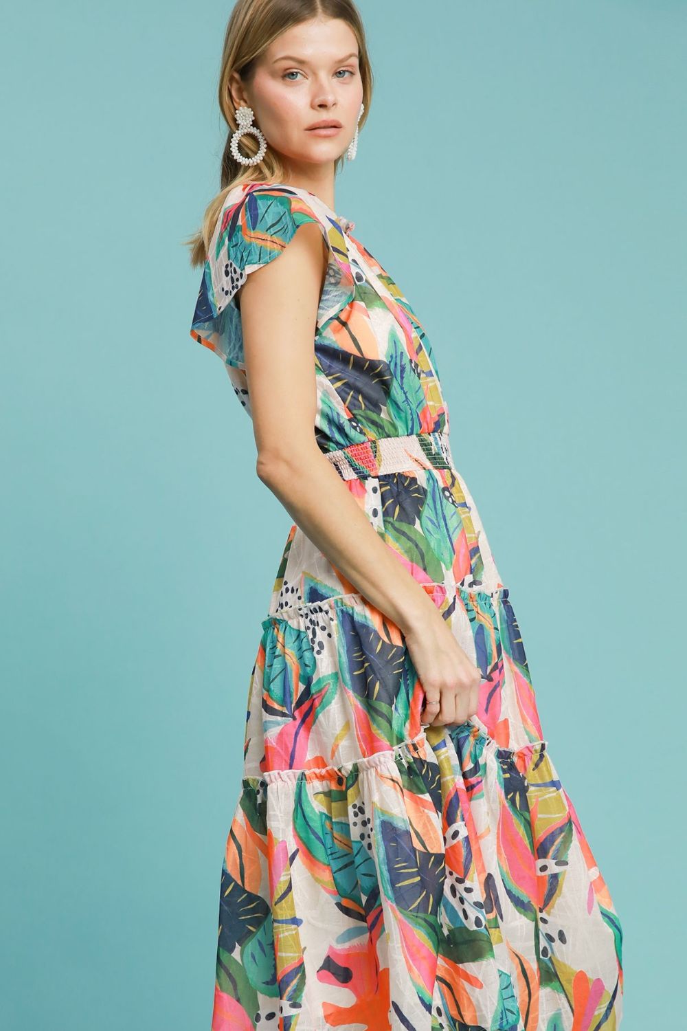 Breezy leaf print tiered midi dress with cap sleeves and a smocked bodice, perfect for summer and vacation styling.