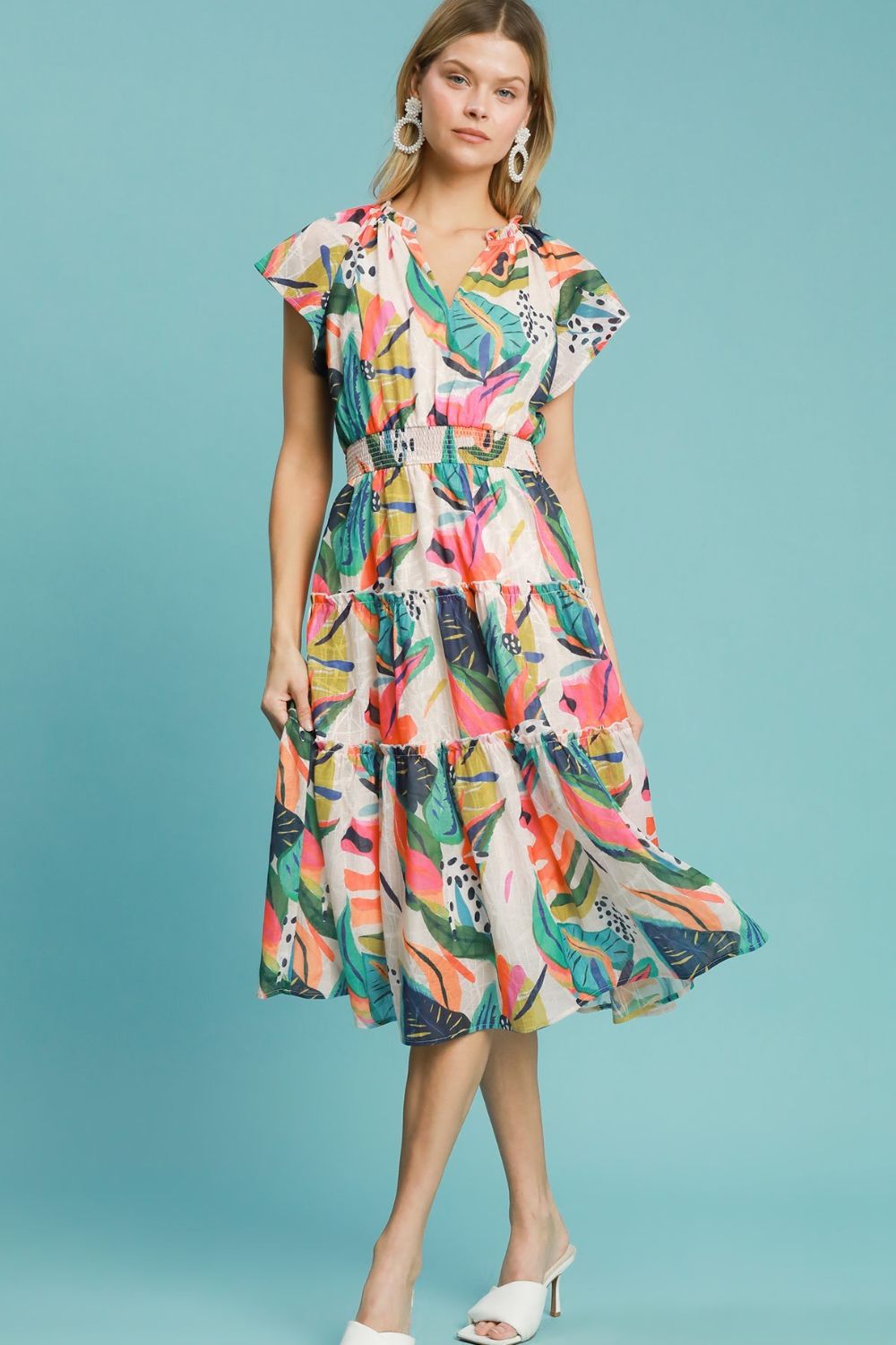 Breezy leaf print tiered midi dress with cap sleeves and a smocked bodice, perfect for summer and vacation styling.