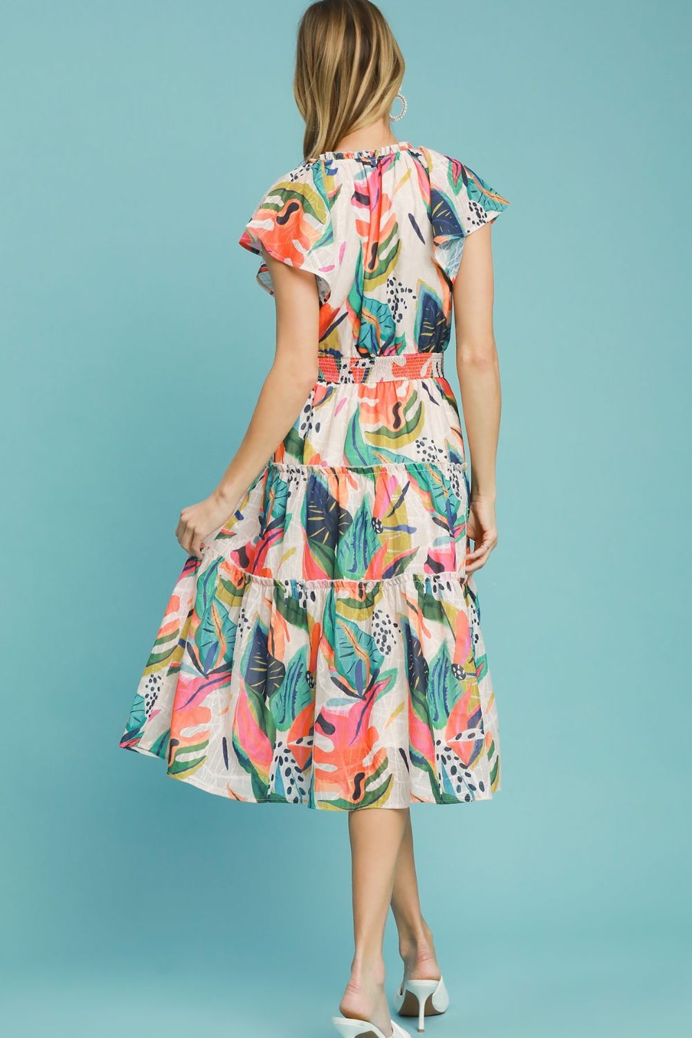 Breezy leaf print tiered midi dress with cap sleeves and a smocked bodice, perfect for summer and vacation styling.