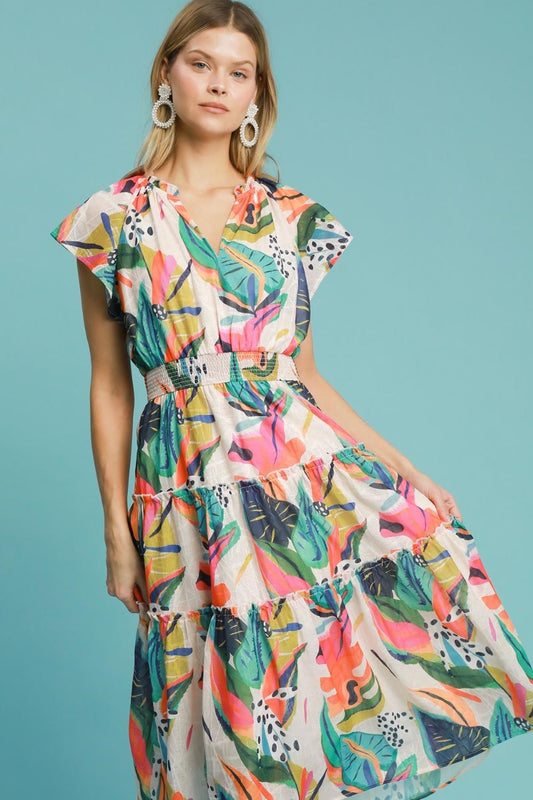 Breezy leaf print tiered midi dress with cap sleeves and a smocked bodice, perfect for summer and vacation styling.