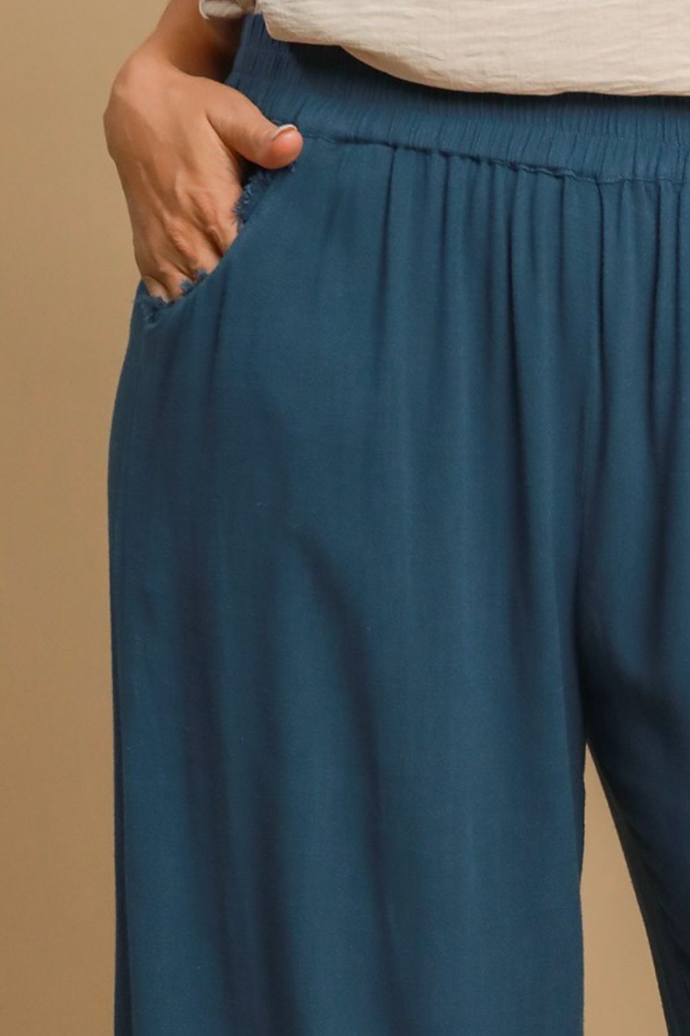 Breathable linen blend wide-leg pants with an elastic waistband and raw hem for a relaxed yet stylish look.