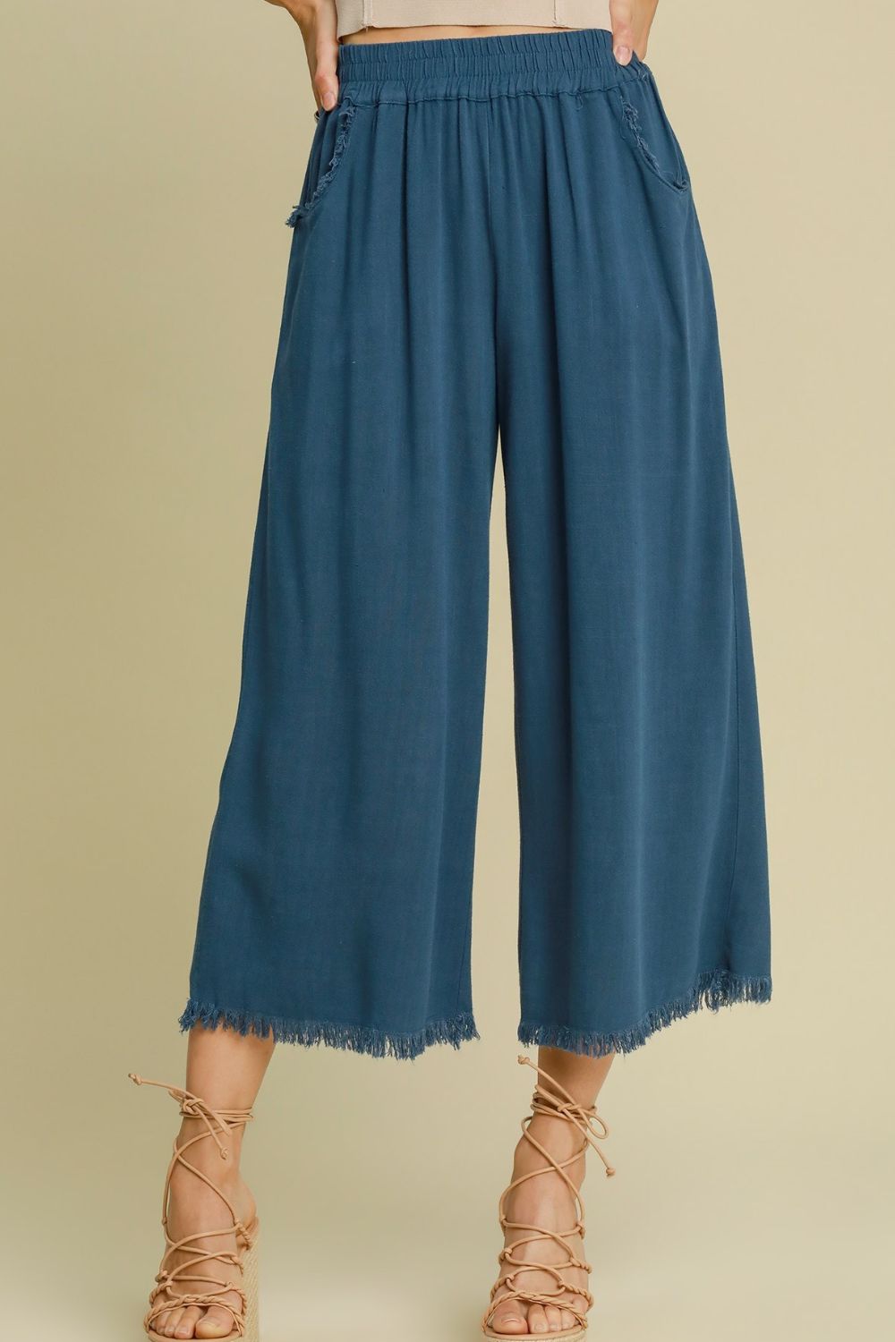 Breathable linen blend wide-leg pants with an elastic waistband and raw hem for a relaxed yet stylish look.