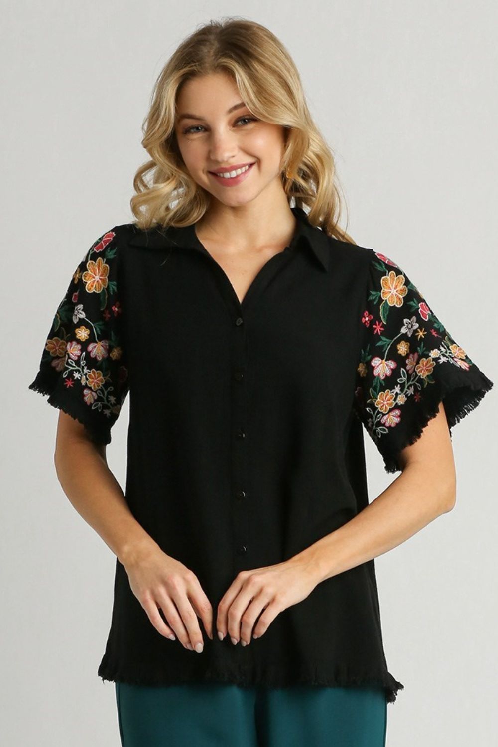 Stylish linen shirt with embroidered sleeves and a raw hem, perfect for a boho-chic and breezy look.