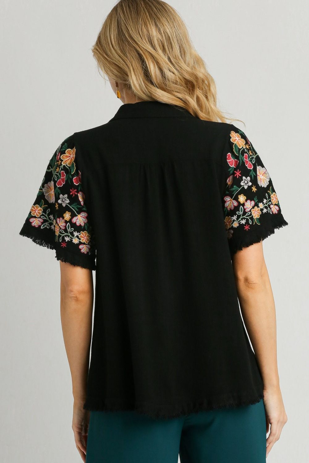 Stylish linen shirt with embroidered sleeves and a raw hem, perfect for a boho-chic and breezy look.