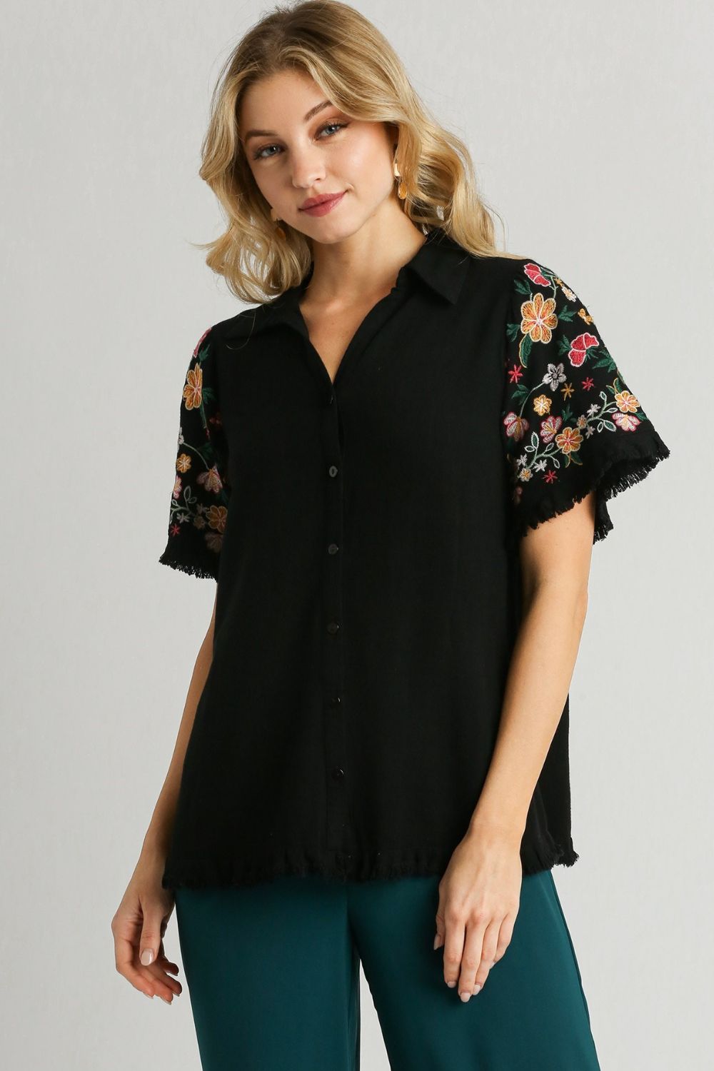 Stylish linen shirt with embroidered sleeves and a raw hem, perfect for a boho-chic and breezy look.