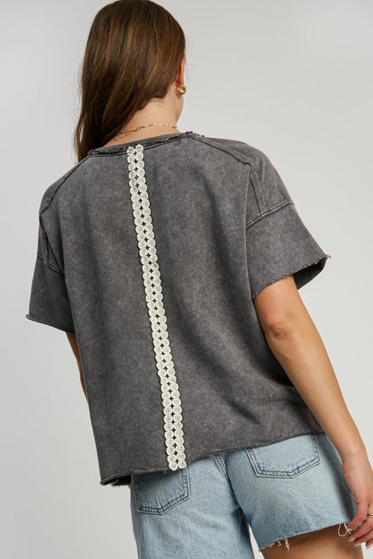 Stylish mineral wash t-shirt with delicate lace applique and exposed seams for a chic, feminine look.