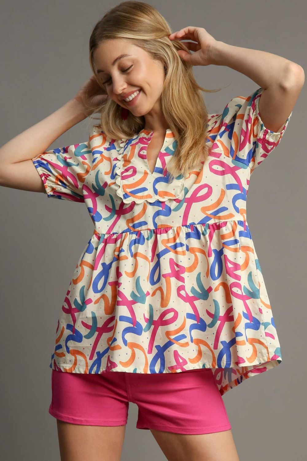 Stylish mixed print babydoll blouse with puff sleeves and a flattering flowy fit, perfect for a fun and feminine look.