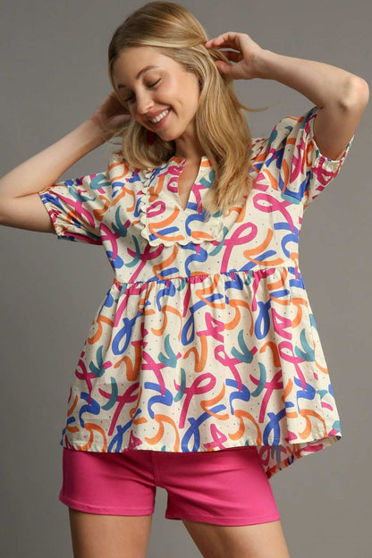 Stylish mixed print babydoll blouse with puff sleeves and a flattering flowy fit, perfect for a fun and feminine look.