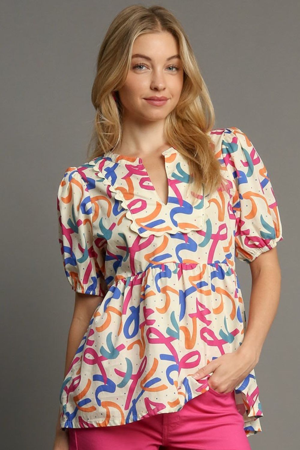 Stylish mixed print babydoll blouse with puff sleeves and a flattering flowy fit, perfect for a fun and feminine look.