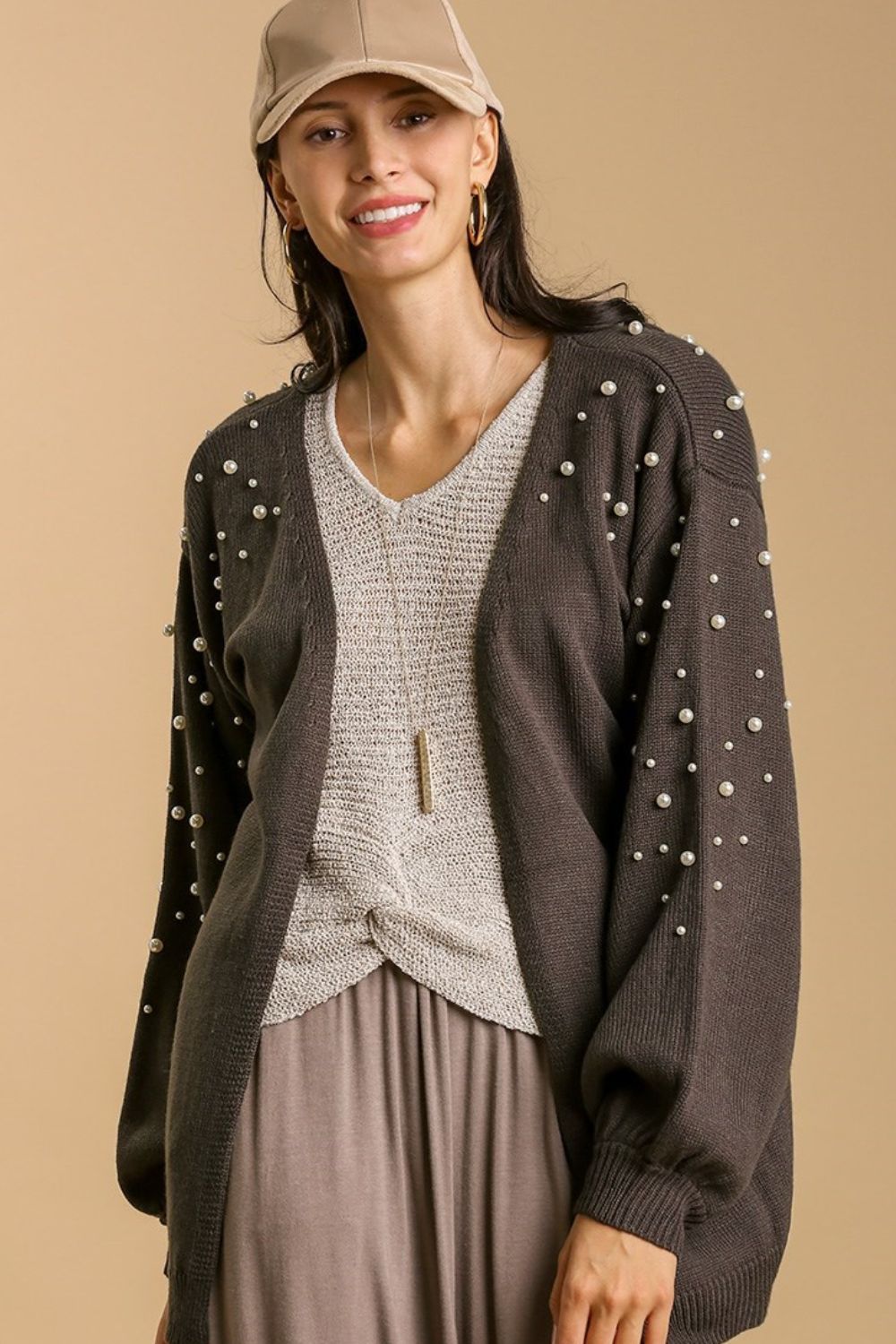 Elegant open front cardigan with long sleeves and pearl details, perfect for layering and adding a touch of sophistication.