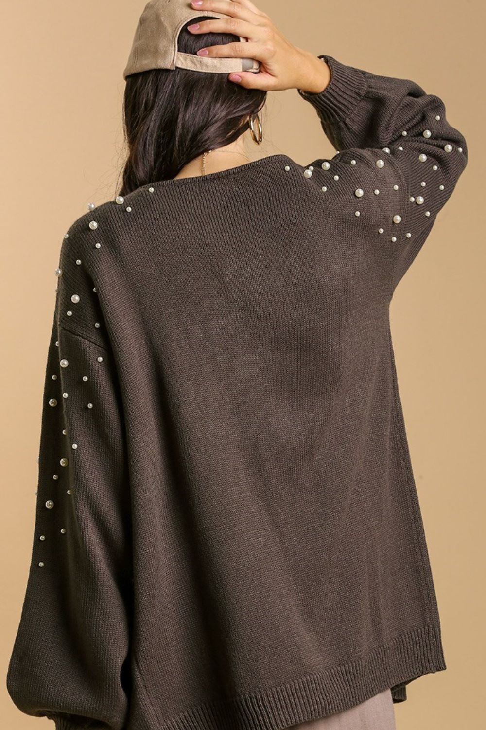 Elegant open front cardigan with long sleeves and pearl details, perfect for layering and adding a touch of sophistication.