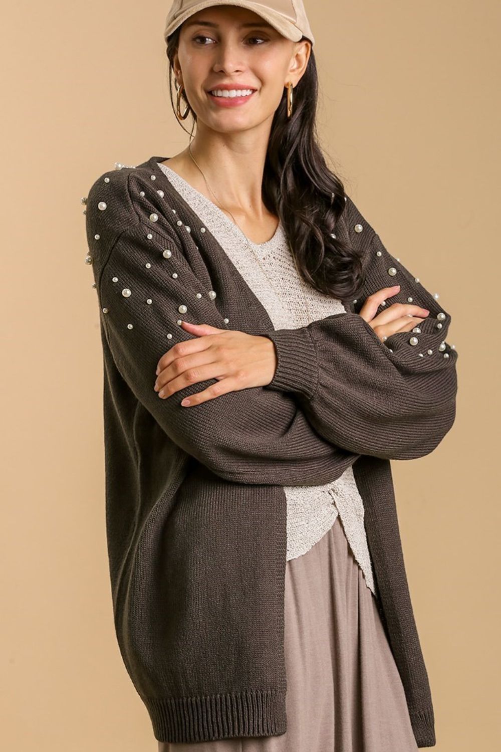 Elegant open front cardigan with long sleeves and pearl details, perfect for layering and adding a touch of sophistication.