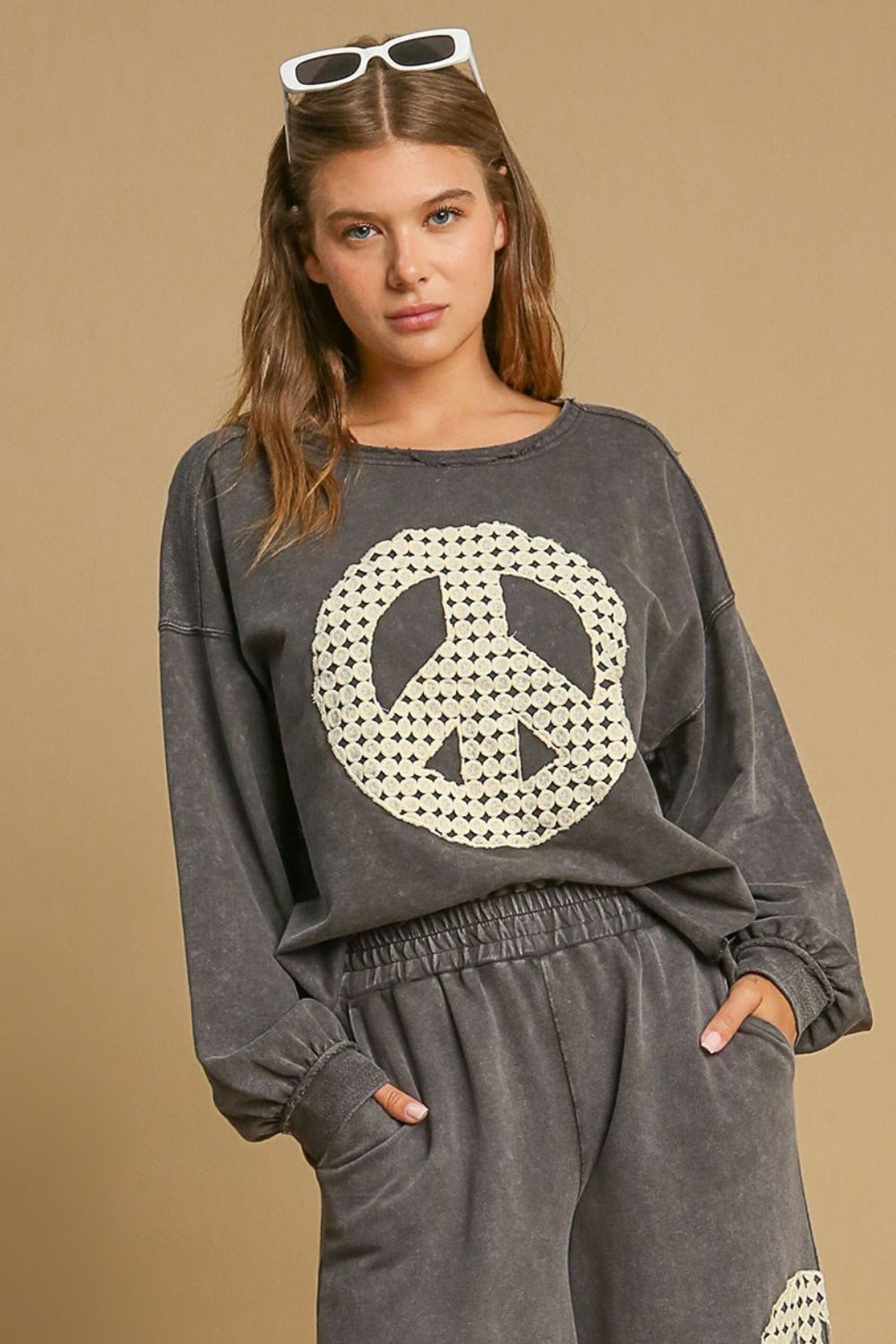 Stylish mineral wash sweatshirt with lace applique details and exposed seams, perfect for a cozy and fashionable look.