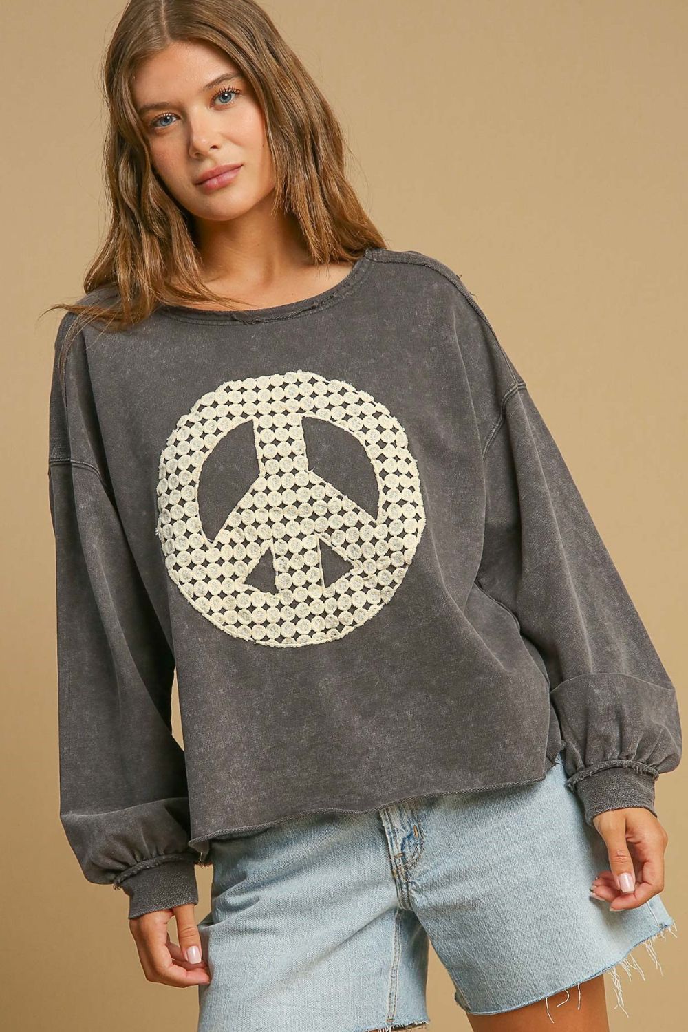 Stylish mineral wash sweatshirt with lace applique details and exposed seams, perfect for a cozy and fashionable look.