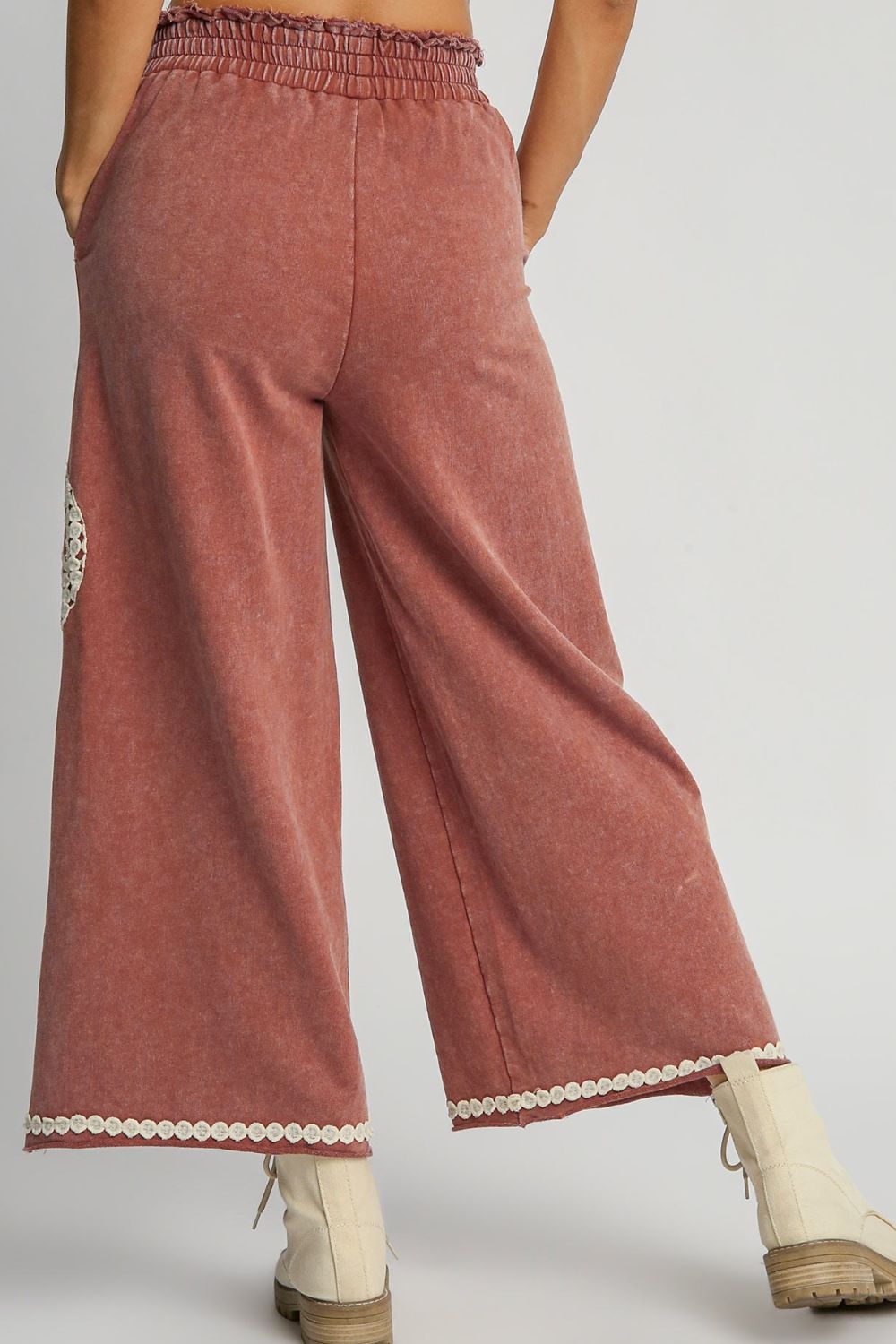 Stylish mineral wash wide-leg pants with lace applique details and a flowy, flattering silhouette, perfect for a chic and effortless look.