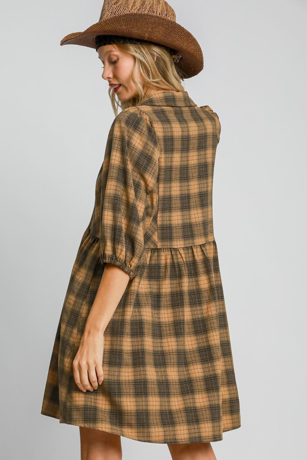 Chic plaid mini shirt dress with a button-front design and collared neckline, perfect for a modern and stylish look.