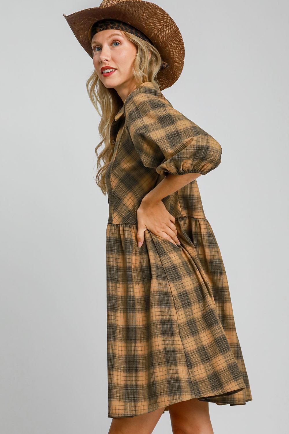 Chic plaid mini shirt dress with a button-front design and collared neckline, perfect for a modern and stylish look.