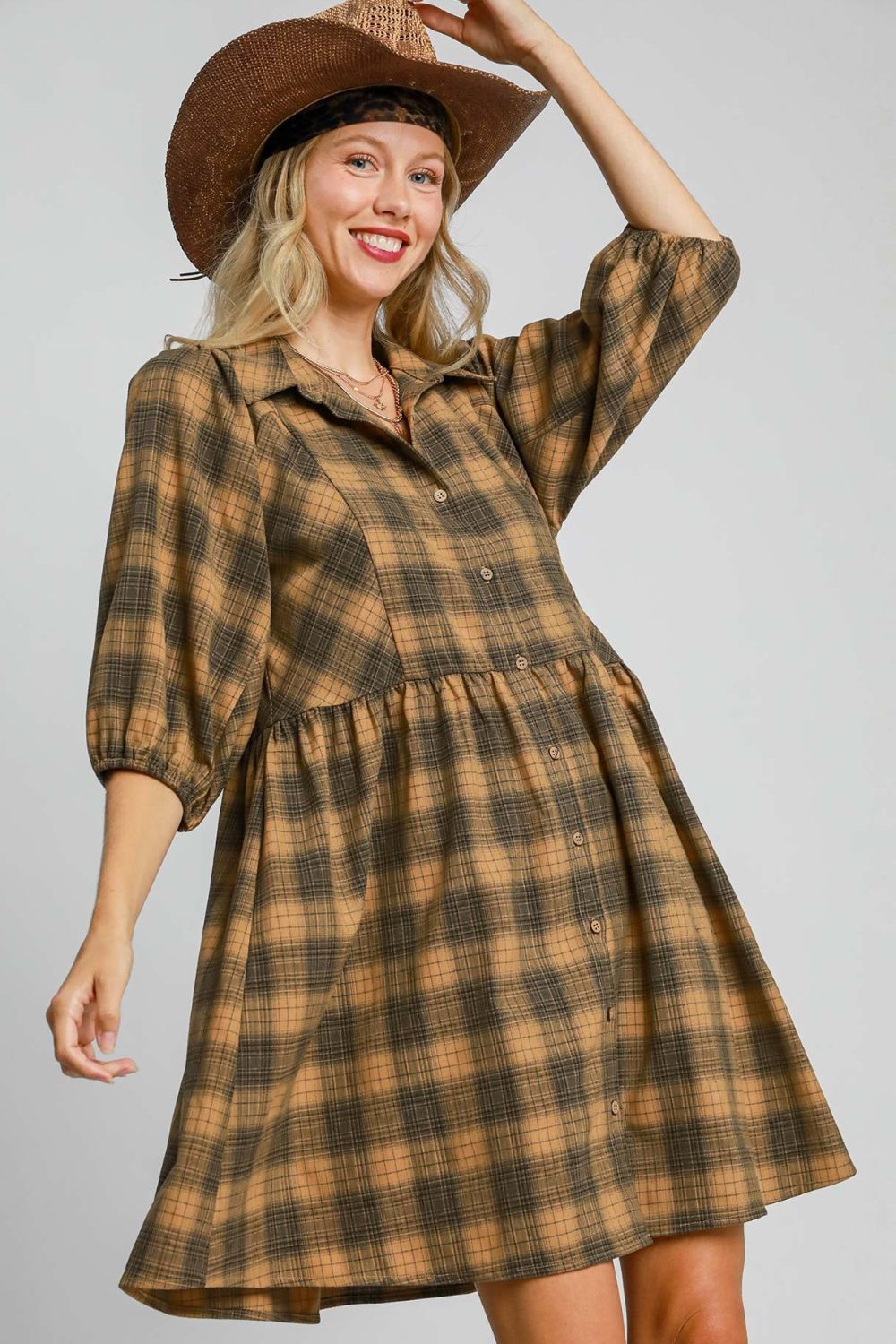 Chic plaid mini shirt dress with a button-front design and collared neckline, perfect for a modern and stylish look.