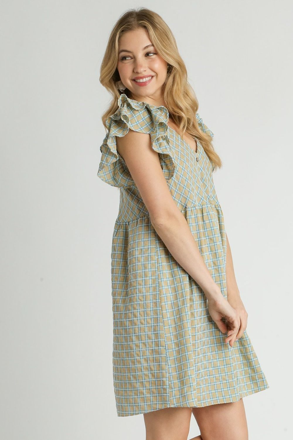 Charming plaid V-neck dress with ruffle cap sleeves, perfect for a feminine and timeless look.