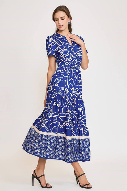 Elegant printed tiered dress with a notched neckline and short sleeves, perfect for a chic and feminine look.