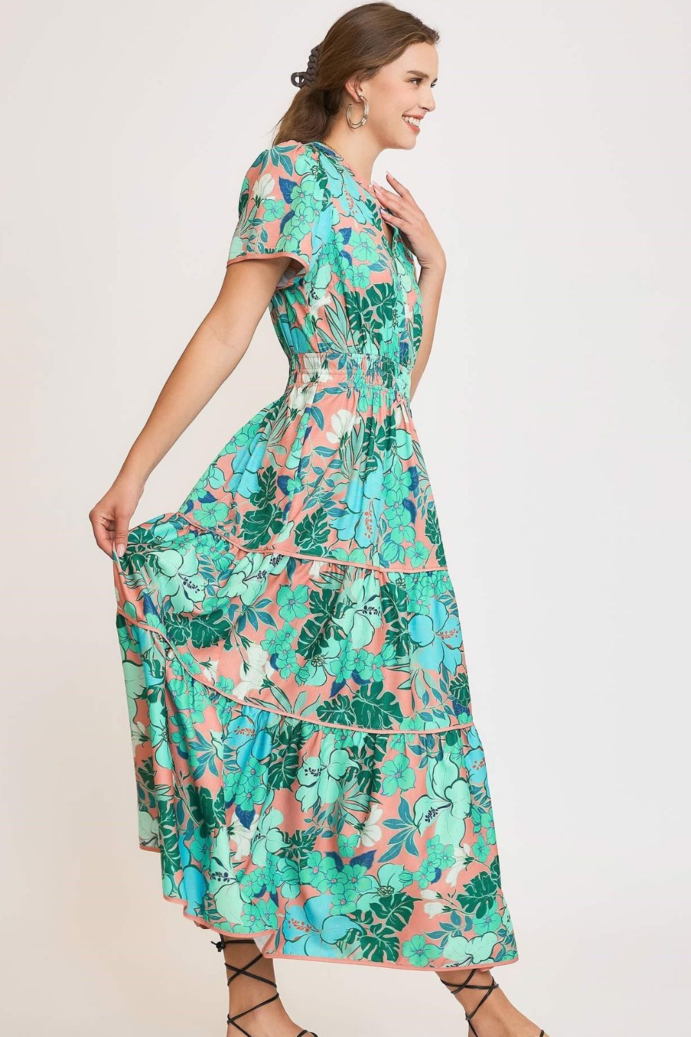 Elegant printed tiered dress with a notched neckline and soft short sleeves, perfect for a chic and feminine style.