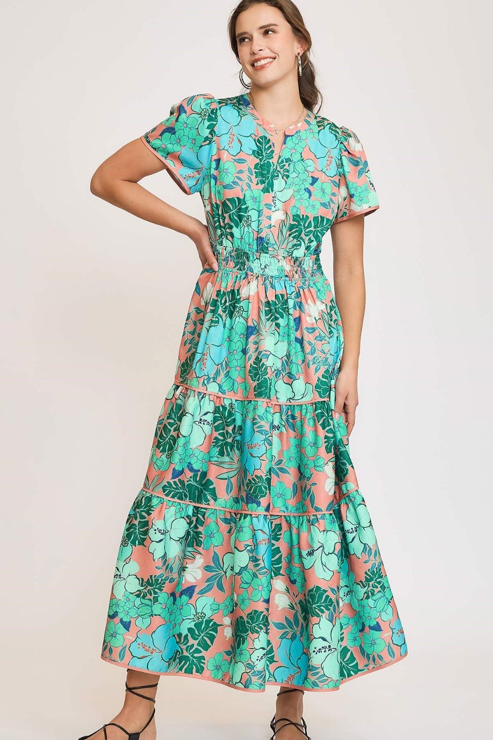 Elegant printed tiered dress with a notched neckline and soft short sleeves, perfect for a chic and feminine style.