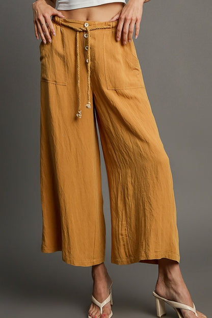 Relaxed wide leg pants with rope drawstring and pockets, perfect for effortless and comfortable plus-size styling.