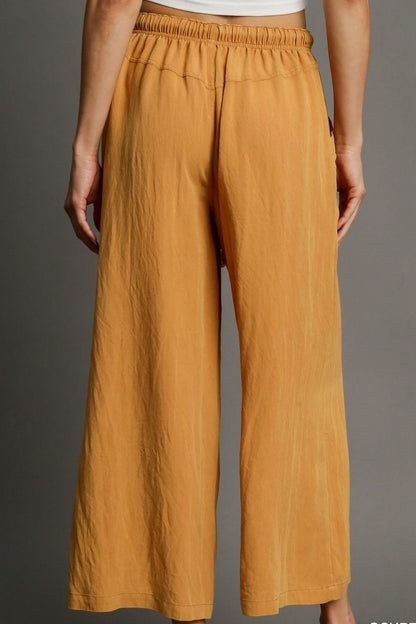 Relaxed wide leg pants with rope drawstring and pockets, perfect for effortless and comfortable plus-size styling.