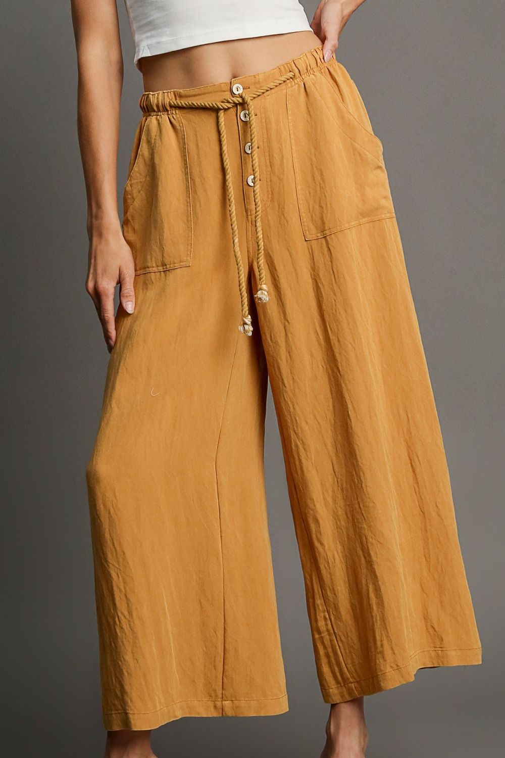 Relaxed wide leg pants with rope drawstring and pockets, perfect for effortless and comfortable plus-size styling.