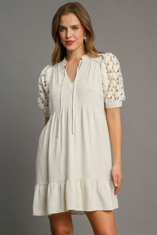 Elegant ruffled hem dress with heart lace sleeves and a tie neck, perfect for a feminine and romantic look.