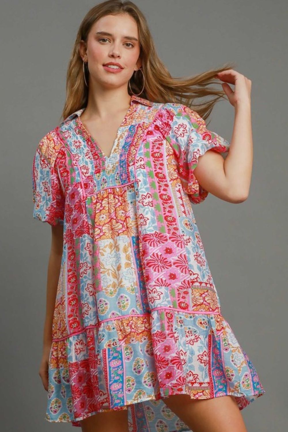 Smocked floral puff sleeve mini dress with a flattering fit and high-low hemline, perfect for feminine plus-size styling.