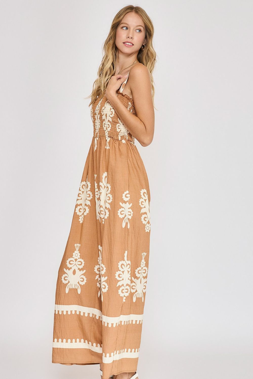 Trendy smocked printed wide-leg jumpsuit with a flattering fit, perfect for casual and summer styling.