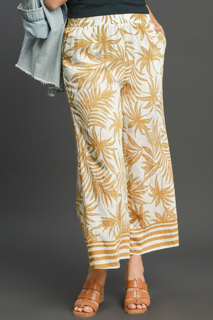 Bold tropical print wide-leg pants with a relaxed fit, perfect for vacations and summer styling.