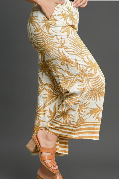 Bold tropical print wide-leg pants with a relaxed fit, perfect for vacations and summer styling.