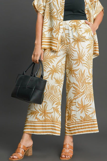 Bold tropical print wide-leg pants with a relaxed fit, perfect for vacations and summer styling.