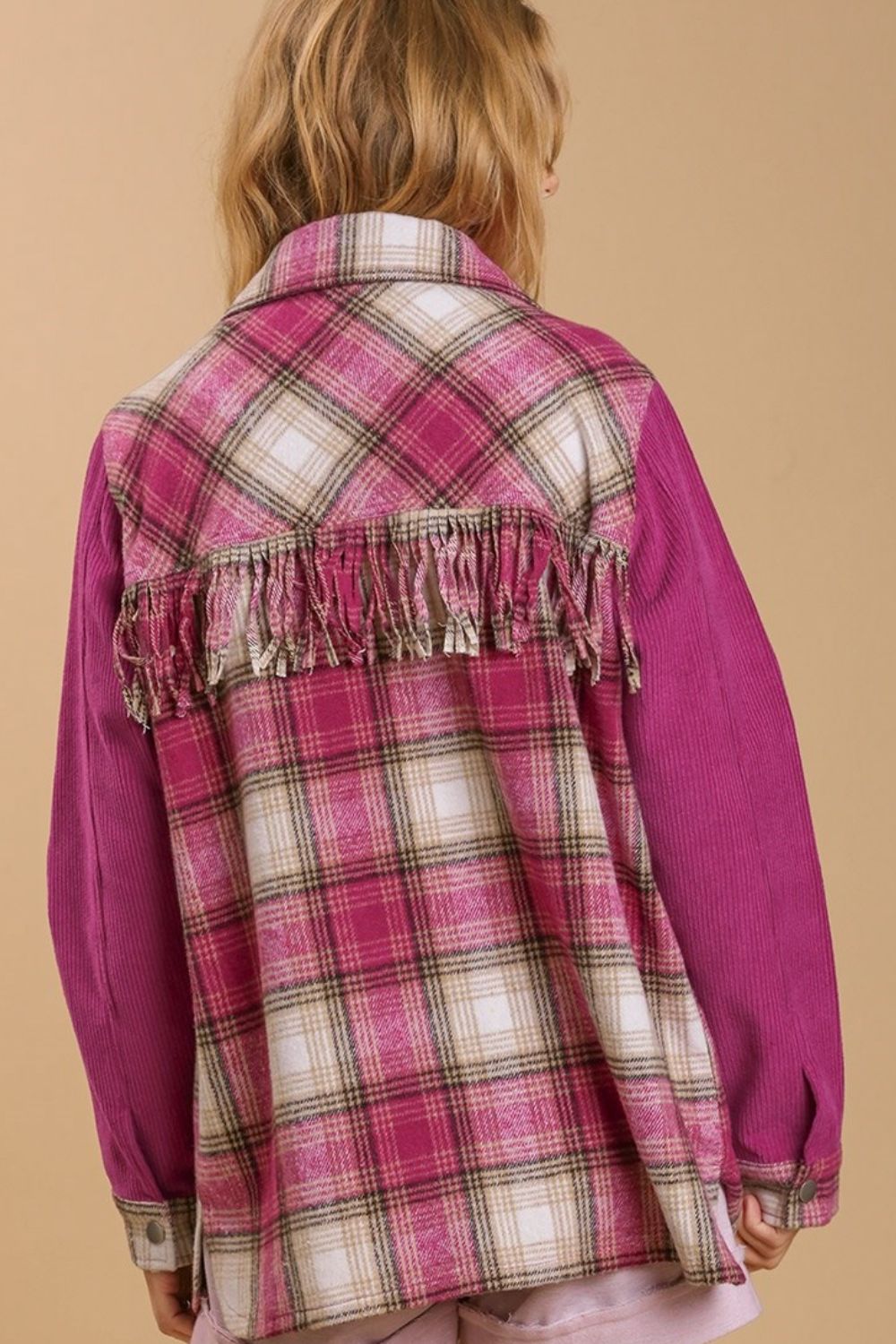 Trendy twill button-down shacket with a stylish fringe back detail and chest pockets, perfect for layering and adding an edgy touch.