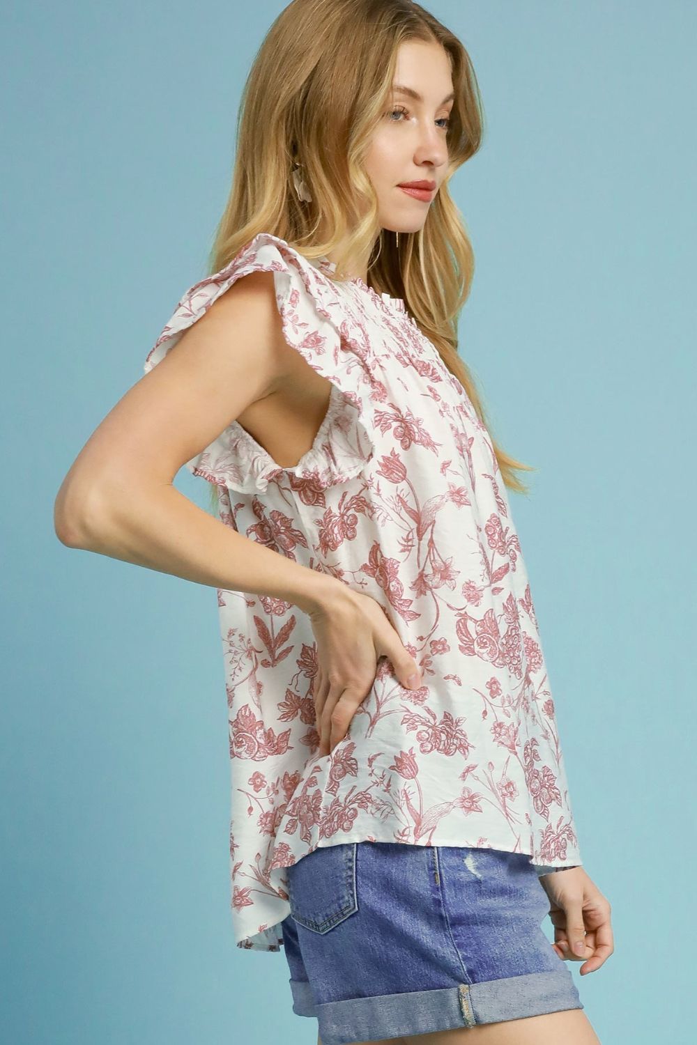 Two-tone floral print blouse with a boxy silhouette and ruffled smocked details, perfect for a stylish and feminine plus-size look.