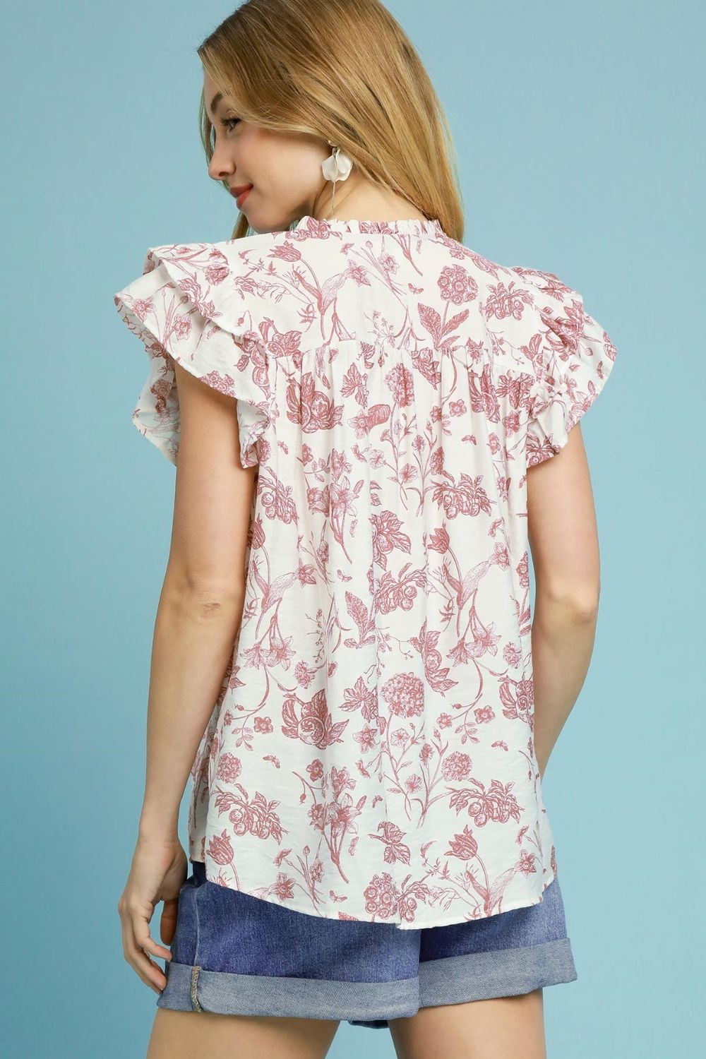 Two-tone floral print blouse with a boxy silhouette and ruffled smocked details, perfect for a stylish and feminine plus-size look.