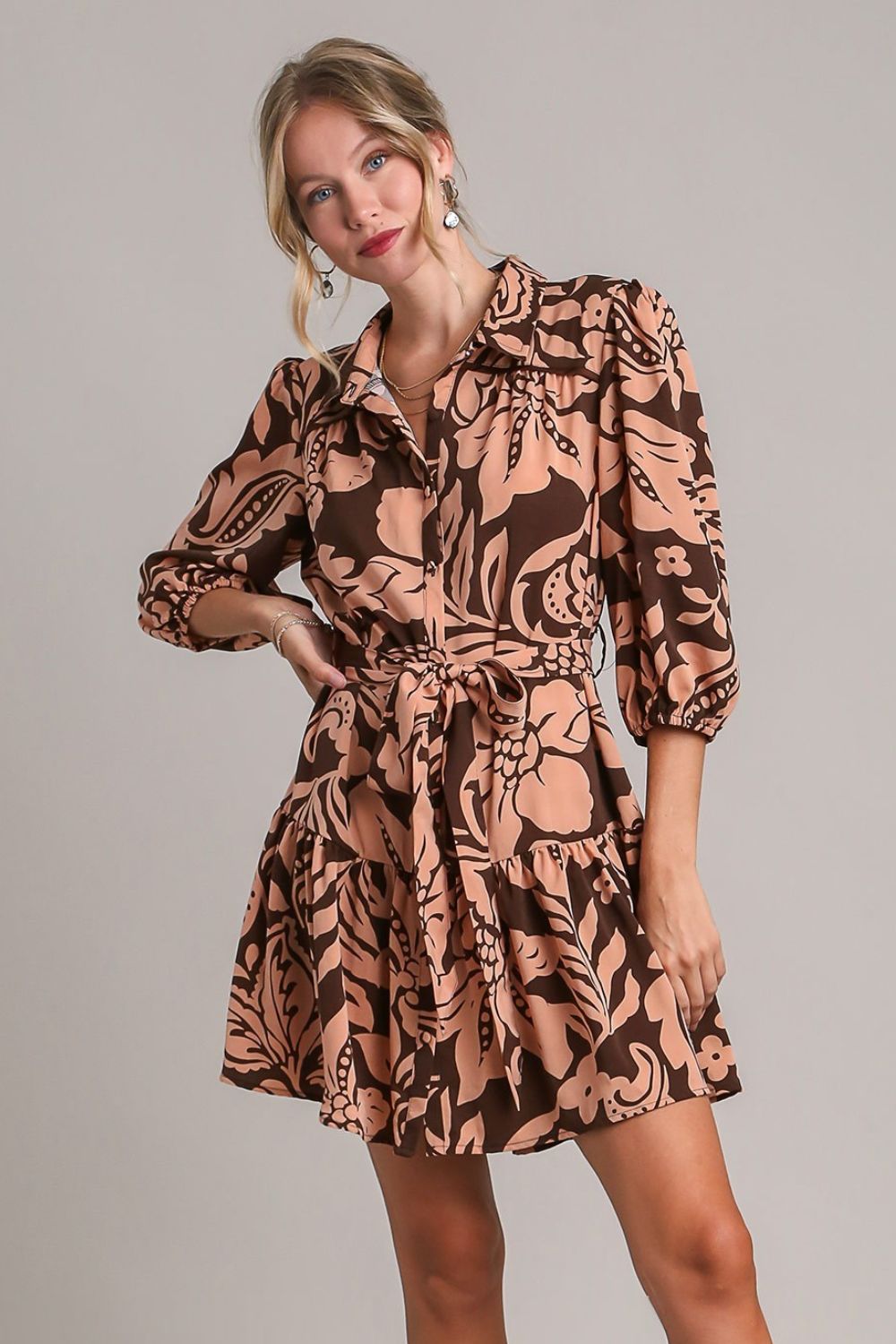 Feminine two-tone floral print dress with puff sleeves and a tie waist, perfect for a chic and elegant look.