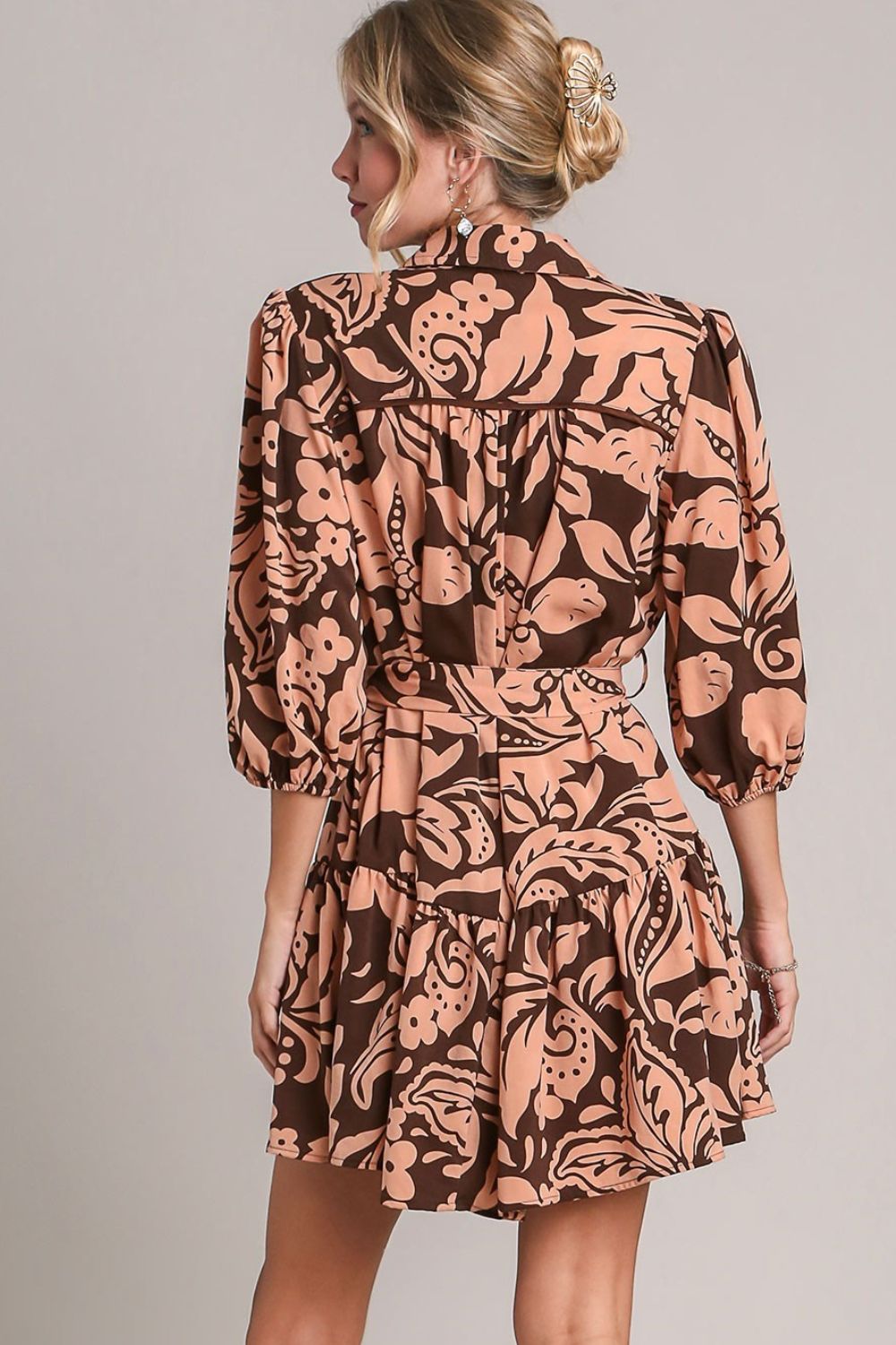 Feminine two-tone floral print dress with puff sleeves and a tie waist, perfect for a chic and elegant look.