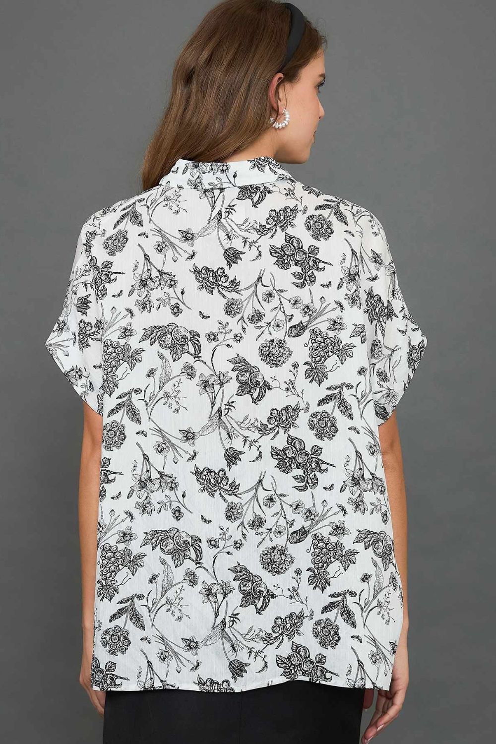 Stylish two-tone floral print top with a high-low hem, perfect for an elegant and versatile look.