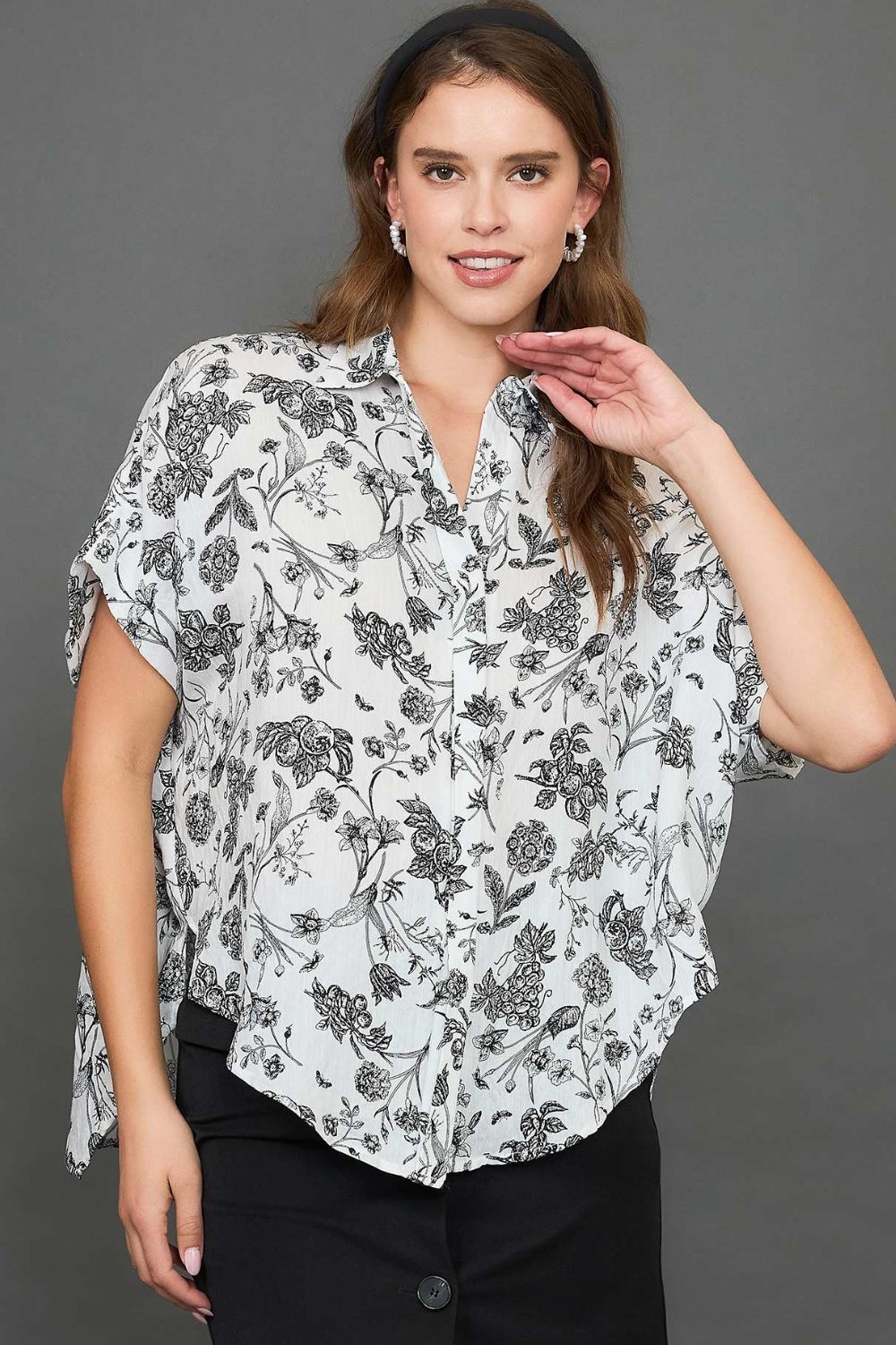 Stylish two-tone floral print top with a high-low hem, perfect for an elegant and versatile look.