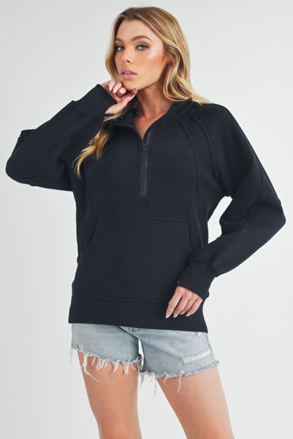 Sporty half-zip raglan sleeve sweatshirt with a kangaroo pocket, perfect for casual and comfortable everyday wear.