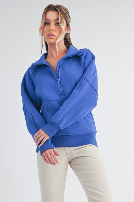 Sporty half zip raglan sleeve sweatshirt with a kangaroo pocket for a relaxed and stylish look.