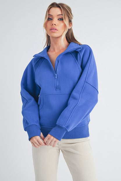 Sporty half zip raglan sleeve sweatshirt with a kangaroo pocket for a relaxed and stylish look.