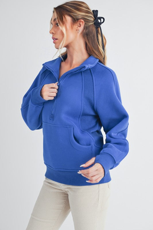 Sporty half zip raglan sleeve sweatshirt with a kangaroo pocket for a relaxed and stylish look.