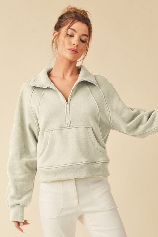 Cozy half-zip raglan sleeve sweatshirt with a kangaroo pocket, perfect for casual and stylish layering.