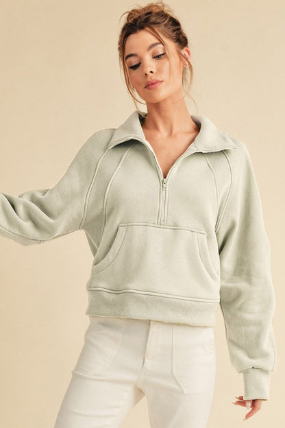 Cozy half-zip raglan sleeve sweatshirt with a kangaroo pocket, perfect for casual and stylish layering.