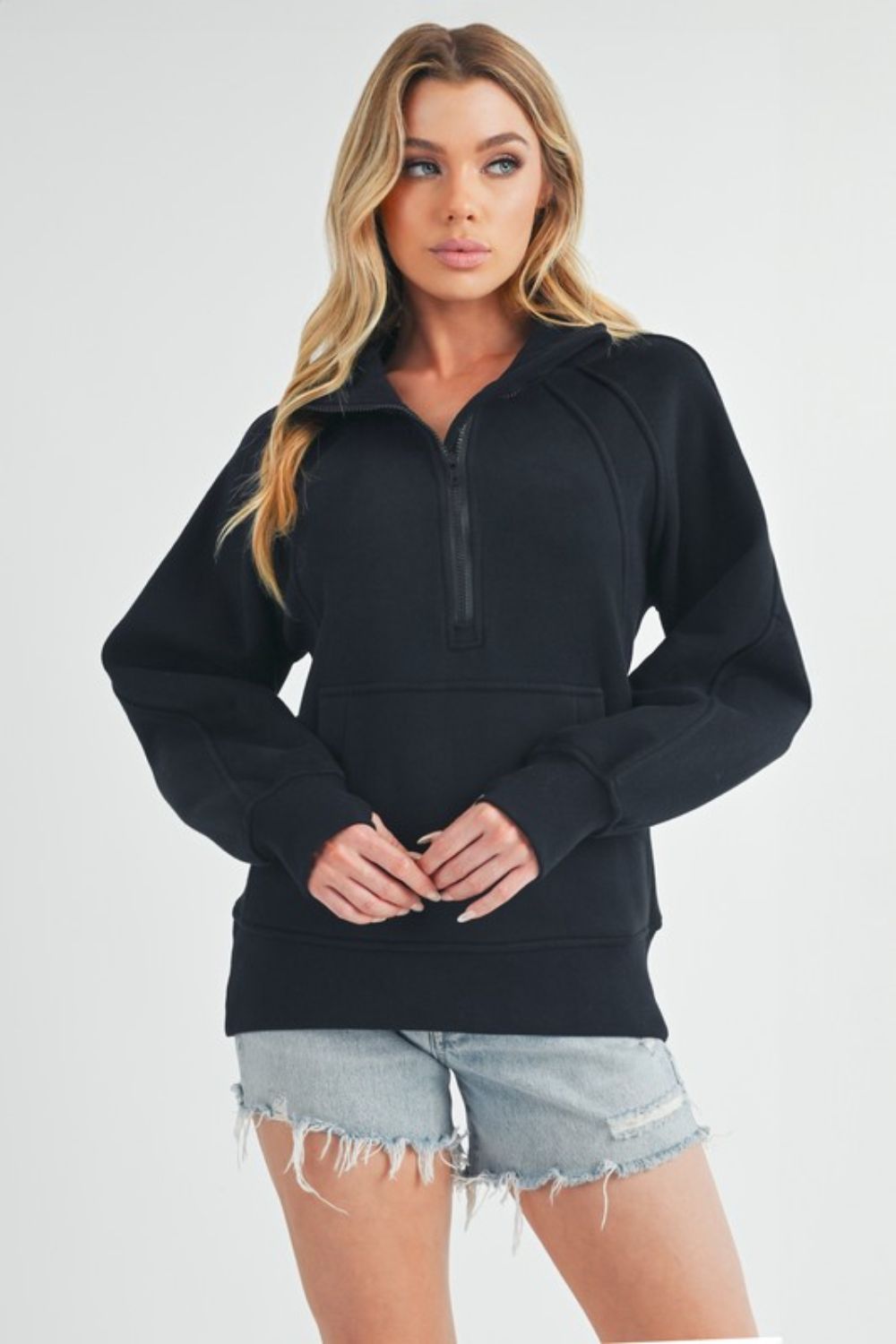 Sporty half-zip raglan sleeve sweatshirt with a kangaroo pocket, perfect for casual and comfortable everyday wear.